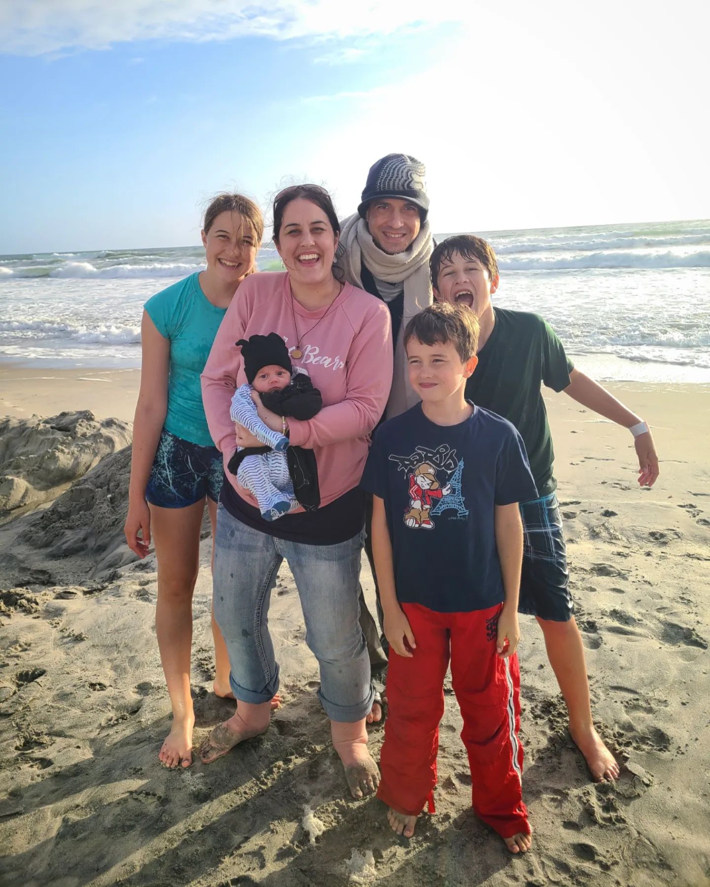 Elisa Johnston with her family walking together on the beach