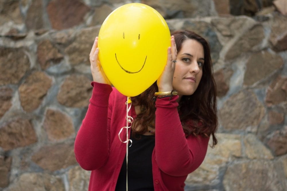 Elisa Johnston speaking on stage during a live event
